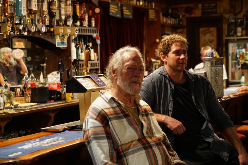 At the bar, mid-conversation
