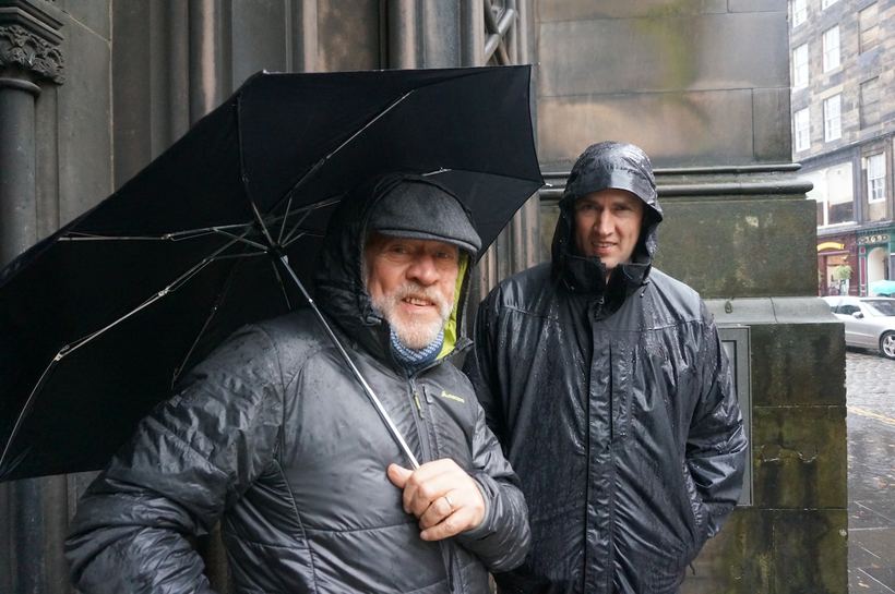 Rain, an umbrella, and one dry sleeve